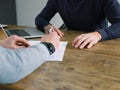 Business, people have meeting round a wooden table at an office