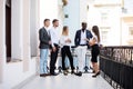 Multiethnic Business people having coffee break at the balcony of office building Royalty Free Stock Photo