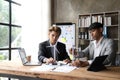 Business people having consultation about wind energy at company office. Business team discussing about windmill and Royalty Free Stock Photo