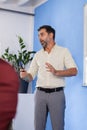 Business people having a creative meeting in an office. Businessman standing at wall board explaining graphs