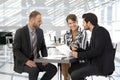 Business people having discussion by coffee table