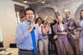 Business people having a karaoke party at the office, singing, dancing and having fun Royalty Free Stock Photo