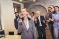 Business people having a karaoke party at the office, singing, dancing and having fun Royalty Free Stock Photo