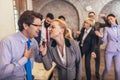 Business people having a karaoke party at the office, singing, dancing and having fun Royalty Free Stock Photo