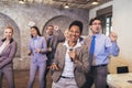 Business people having a karaoke party at the office, singing, dancing and having fun Royalty Free Stock Photo