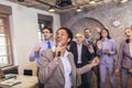 Business people having a karaoke party at the office, singing, dancing and having fun Royalty Free Stock Photo