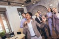 Business people having a karaoke party at the office, singing, dancing and having fun Royalty Free Stock Photo