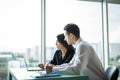 Business people Having Meeting Around Table In Modern Office against windows. Royalty Free Stock Photo