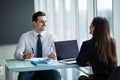 Business people Having Meeting Around Table In Modern Office. Young man listen woman in office Royalty Free Stock Photo