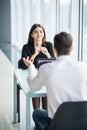 Business people man and woman Having Meeting at Table In Modern Office against panoramic windows. Focus on woman. Royalty Free Stock Photo