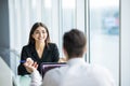 Business people man and woman Having Meeting at Table In Modern Office against panoramic windows. Focus on woman. Royalty Free Stock Photo