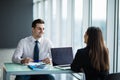 Business people Having Meeting Around Table In Modern Office. Young man listen woman in office Royalty Free Stock Photo