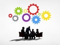 Business People Having a Meeting and Gears Above Royalty Free Stock Photo