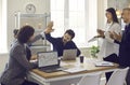 Two men make a business deal and high five each other sitting at an office table in a meeting Royalty Free Stock Photo