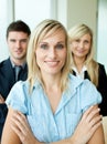Business people headed by a woman with folded arms Royalty Free Stock Photo