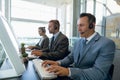Business people with headset working on computer at desk Royalty Free Stock Photo