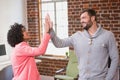 Business people high fiving at office