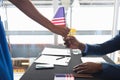 Business people holding an American flag at conference registration table Royalty Free Stock Photo