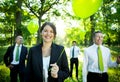 Business People Holding Green Balloon In Forest