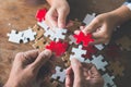 Business people Holding Jigsaw Puzzle, group of business people using a jigsaw puzzle to demonstrate the need to work in the same Royalty Free Stock Photo