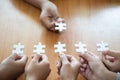 Business people Holding Jigsaw Puzzle, group of business people using a jigsaw puzzle to demonstrate the need to work in the same Royalty Free Stock Photo