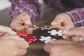 Business people Holding Jigsaw Puzzle, group of business people using a jigsaw puzzle to demonstrate the need to work in the same Royalty Free Stock Photo