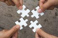 Business people Holding Jigsaw Puzzle, group of business people using a jigsaw puzzle to demonstrate the need to work in the same Royalty Free Stock Photo