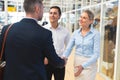 Business people interacting with each other in corridor at office Royalty Free Stock Photo