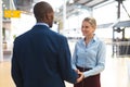 Business people interacting with each other in corridor at office Royalty Free Stock Photo