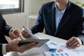 Business people investor group discussing financial graph chart document together on desk in meeting room office Royalty Free Stock Photo