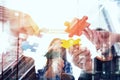 Business people join puzzle pieces in office. Concept of teamwork and partnership. double exposure with light effects Royalty Free Stock Photo