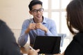 Business people laughing together while discussing paperwork during a meeting. Royalty Free Stock Photo