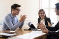 Business people laughing together while discussing paperwork during a meeting. Royalty Free Stock Photo