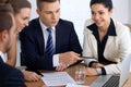 Business people or lawyers at meeting in the office. Focus on a man pointing into laptop