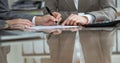 Business people or lawyers signing contract at meeting. Close-up of human hands at work Royalty Free Stock Photo