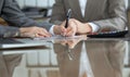 Business people or lawyers signing contract at meeting. Close-up of human hands at work Royalty Free Stock Photo