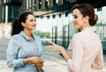 Business, people and lifestyle concept: Two business women having a casual meeting or discussion in the city. Royalty Free Stock Photo