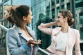 Business, people and lifestyle concept: Two business women having a casual meeting or discussion in the city. Royalty Free Stock Photo