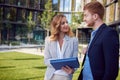 Business people looking interested each other in front of a building