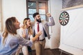 Business people making team training exercise during team building seminar, play darts. Royalty Free Stock Photo