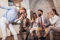 Business people making team training exercise during team building seminar singing karaoke Royalty Free Stock Photo