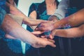 Business people male and female stacking hands together with overlay of world map and technology sign Royalty Free Stock Photo