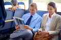 Business people, man and woman in bus or public transport for travel and commute outdoors against blurred background Royalty Free Stock Photo