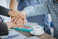 Business people man and women putting their hands group together. On the desk office table in the meeting room. Royalty Free Stock Photo