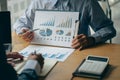 Business people meet with design ideas business planning Picture of two young businessmen holding pens and graph papers at a meeti Royalty Free Stock Photo