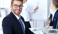 Business people at meeting in office. Focus at cheerful smiling bearded man wearing glasses. Conference, corporate Royalty Free Stock Photo