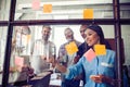 Business people meeting at office and use post it notes to share idea. Brainstorming concept. Sticky note on glass wall Royalty Free Stock Photo