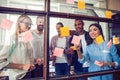 Business people meeting at office and use post it notes to share idea. Brainstorming concept. Sticky note on glass wall Royalty Free Stock Photo