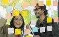 Business people meeting at office and use post it notes to share idea. Brainstorming concept. Sticky note on glass wall Royalty Free Stock Photo