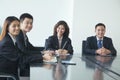 Business people in meeting room, smiling, looking at camera